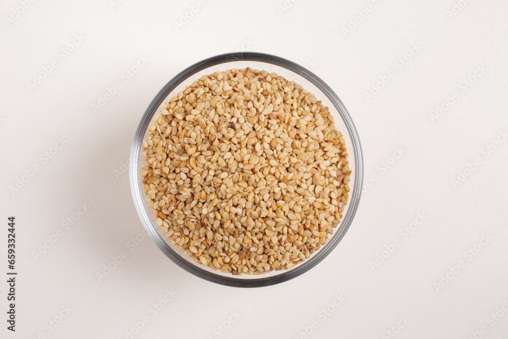 sesame seeds in glass bowl on white background shot from above sesame seeds in glass bowl on white background shot from above