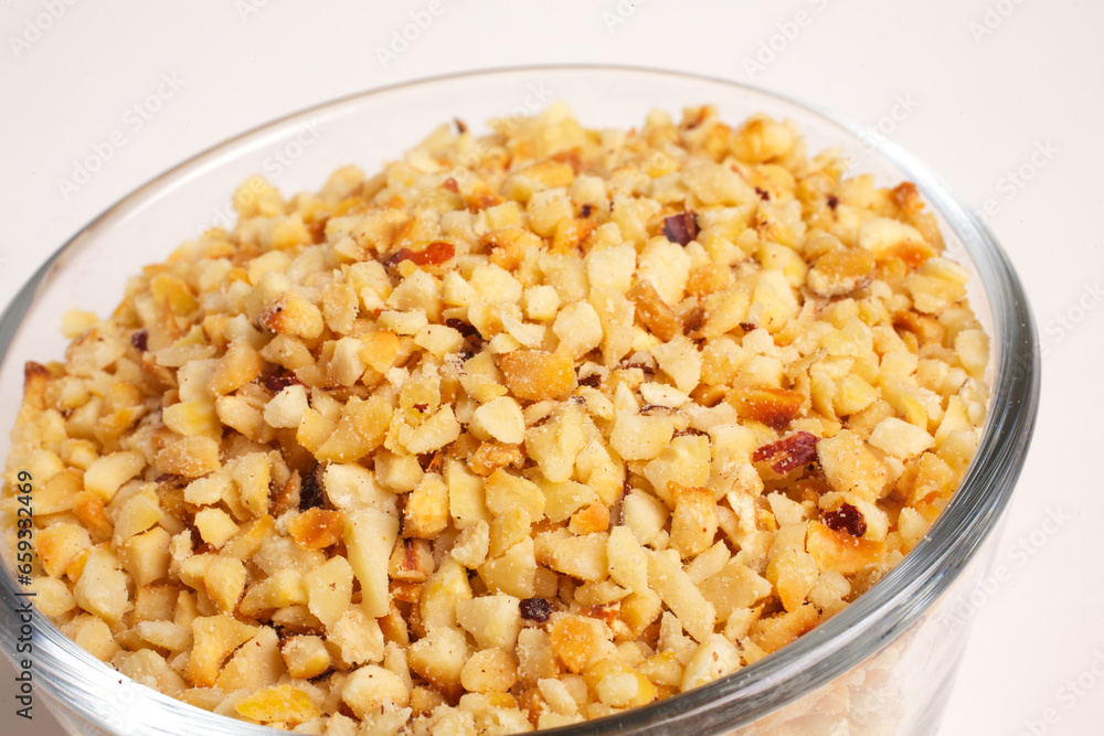 chopped hazelnuts in glass bowl on white background top view chopped hazelnuts in glass bowl on white background top view