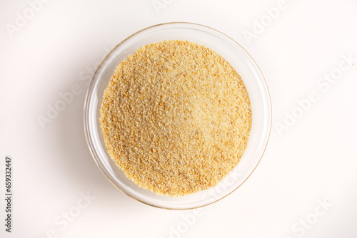breadcrumbs in glass bowl on white background shot from above