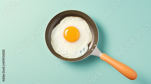 top view of a pan with single fried egg on pastel background photo