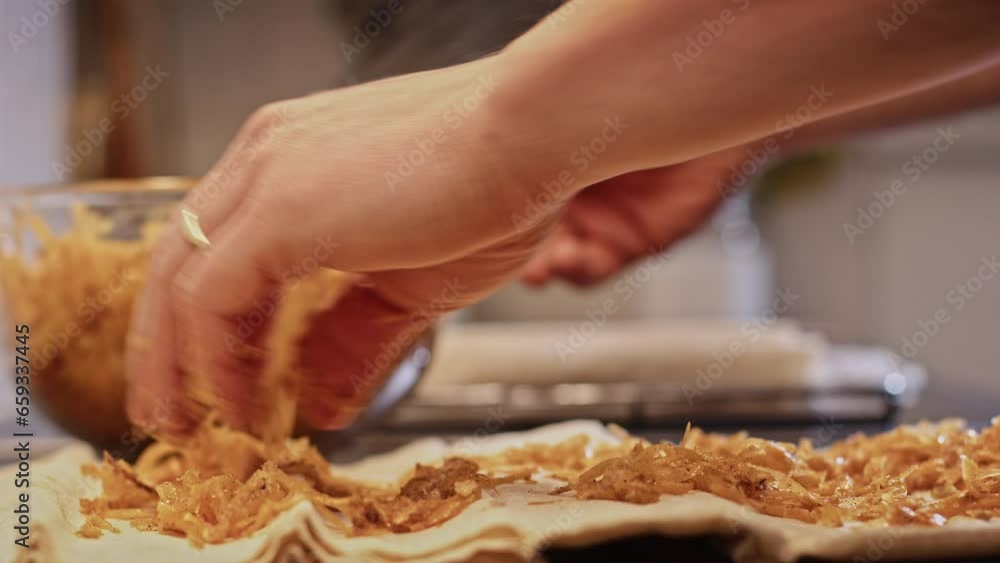Making tikvenik - a Bulgarian pumpkin pastry with filo dough, cinnamon and walnuts. Closeup low angle shot. Making tikvenik - a Bulgarian pumpkin pastry with filo dough, cinnamon and walnuts. Closeup low angle shot.