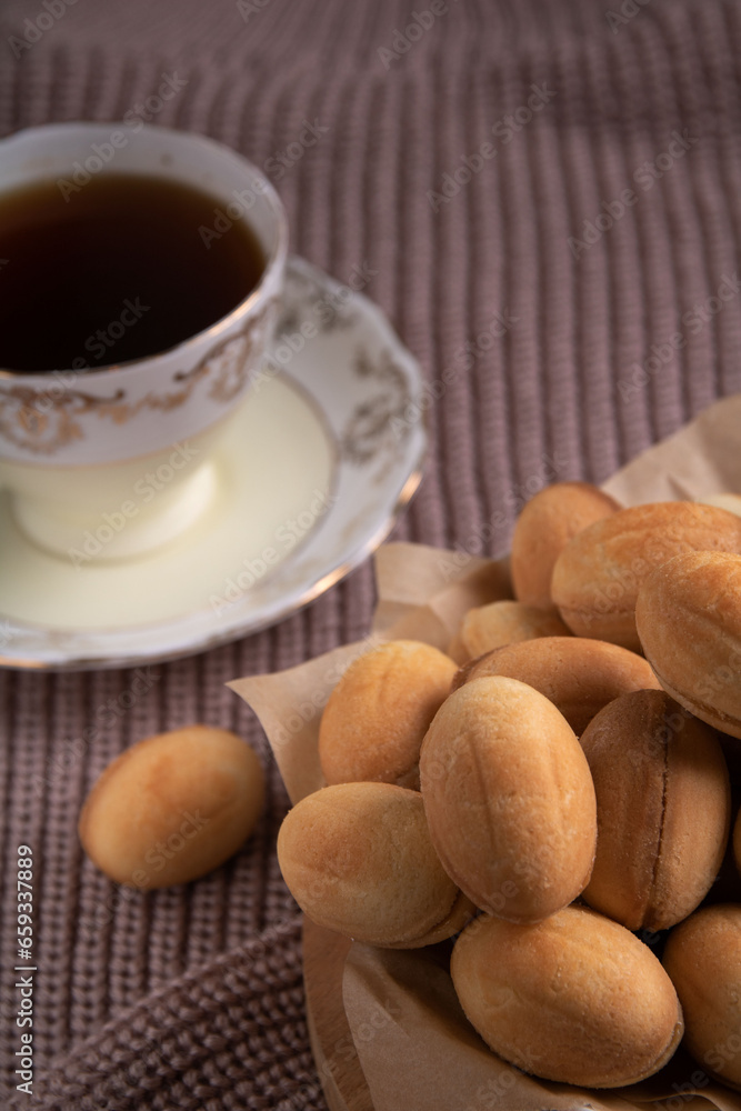 Photography showcases a delicious dessert scene. Homemade cookies, drizzled with sweet condensed milk, sit on a warm sweater background. Photography showcases a delicious dessert scene. Homemade cookies, drizzled with sweet condensed milk, sit on a warm sweater background.