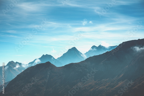 Beautiful mountain peaks against the background of the day blue sky