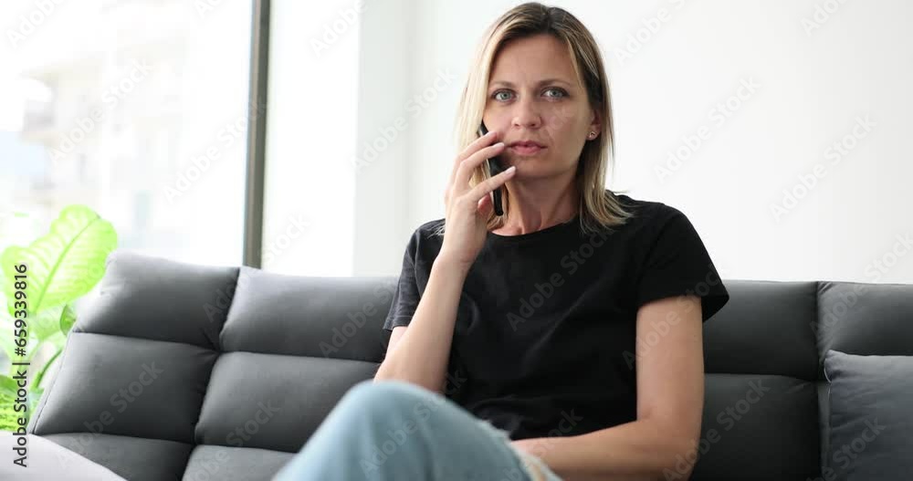 Woman talking on mobile phone and looking at camera suspiciously 4k movie slow motion. Spy apps for mobile phones tracking concept Woman talking on mobile phone and looking at camera suspiciously 4k movie slow motion. Spy apps for mobile phones tracking concept