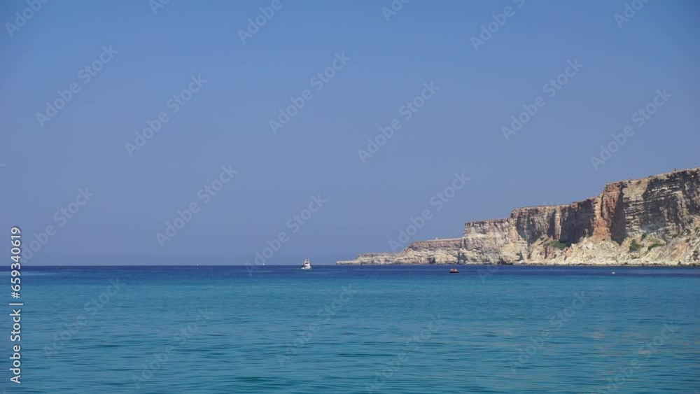 Sea landscape with yachts and rocky coastline. Yachts in the Sea on a background of rocky shores. The concept of perfect place for summer travel and rest. Sea landscape with yachts and rocky coastline. Yachts in the Sea on a background of rocky shores. The concept of perfect place for summer travel and rest.