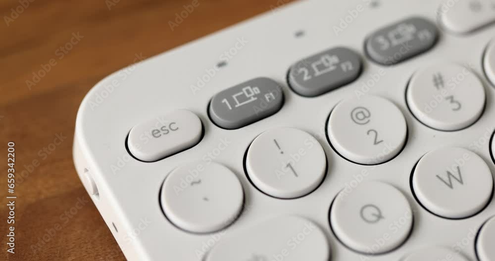 Woman finger pressing escape button on white computer keyboard closeup 4k movie slow motion. Esc sign and symbol 