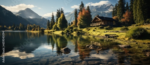 Beautiful alpine lake with a wooden house on the shore.