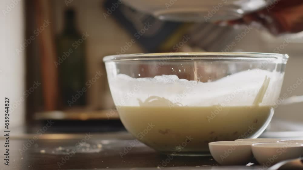 Home cooking - a man making batter mix for quiche Lorraine. Low angle closeup shot. Home cooking - a man making batter mix for quiche Lorraine. Low angle closeup shot.