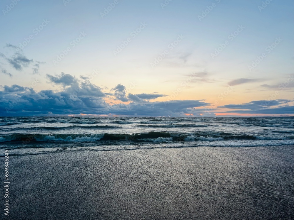 Fototapeta premium Cloudy seascape, sea shoreline, sunset time