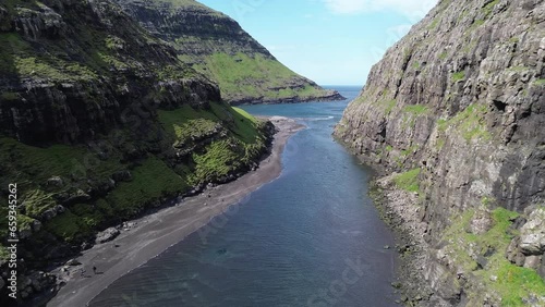 Rocky coastline with canyon and river  from drone near Saksun, Faroe Islands in the Atlantic Ocean.  photo