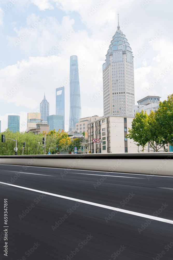 Naklejka premium financial district buildings of shanghai and empty highway in sunny day