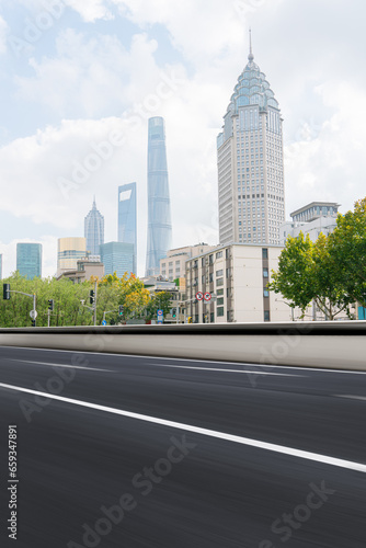 financial district buildings of shanghai and empty highway in sunny day