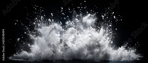 White powder explosion isolated on black background. White dust particles splash.Color Holi Festival. photo