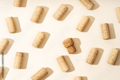 Bild auf Leinwand Pattern with wine and champagne corks, sun glare from a champagne bottle on a beige background with hard sunlight and shadow