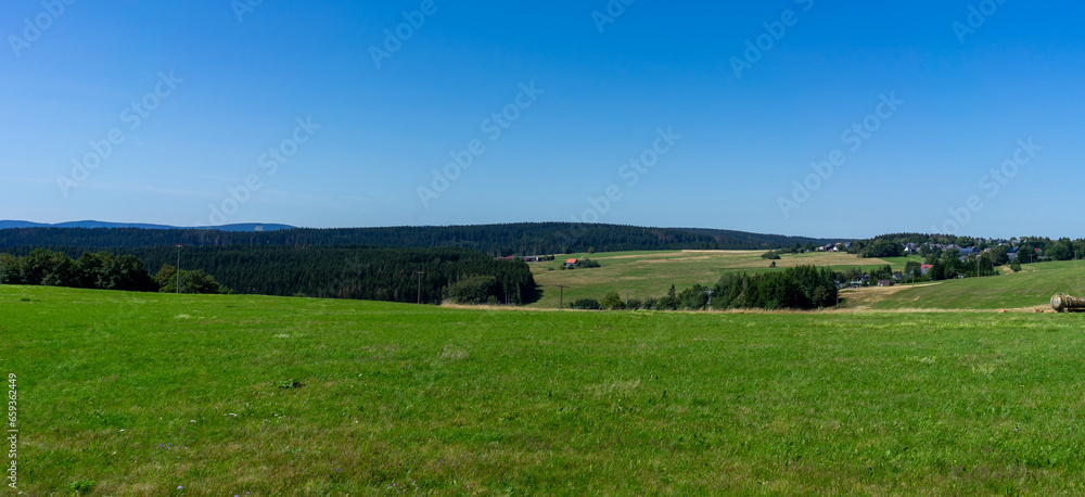 panorama landscape Thuringian Forest with meadow and blue sky