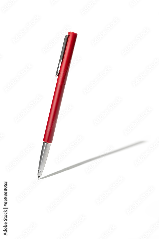 Detailed red classic ballpoint pen writing on white surface with its shadow. Isolated on white background with clipping path

