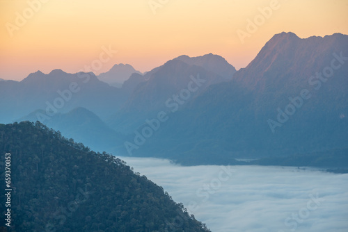 Aerial view of misty mountains at sunrise