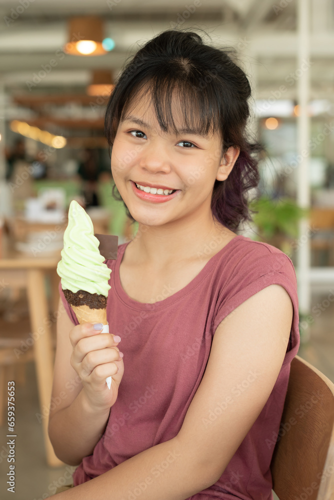Happy teen girl 11-15 year old. Beautiful young asian woman eating ice cream, Cheerful asian female portrait during summertime vacation, Leisure, people and lifestyle concepts, cafe. Happy teen girl 11-15 year old. Beautiful young asian woman eating ice cream, Cheerful asian female portrait during summertime vacation, Leisure, people and lifestyle concepts, cafe.