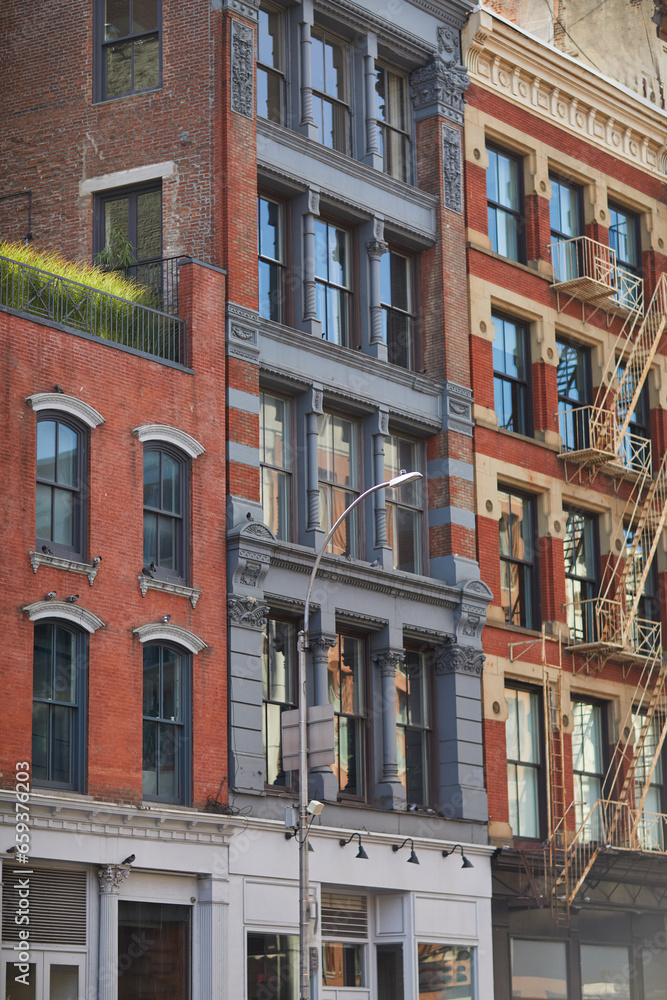 vintage buildings with fire escape stairs in downtown of new york city, streetscape in autumn