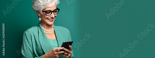 Image of adult mature woman with grey white hair holding cellphone