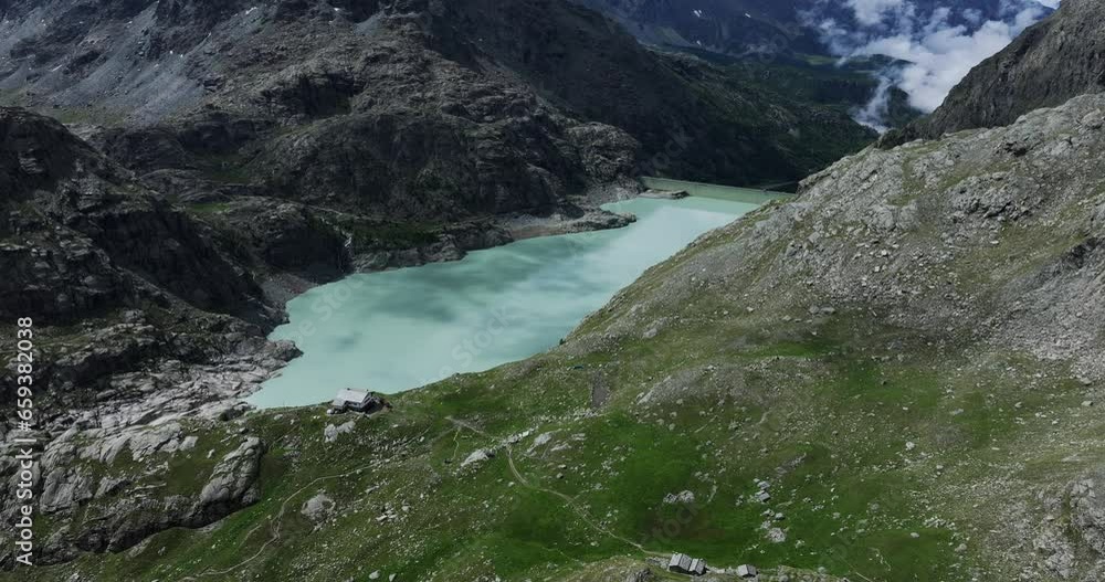 Alpe Gera dam and reservoir, Fellaria in Valmalenco, Italy. Aerial drone view Alpe Gera dam and reservoir, Fellaria in Valmalenco, Italy. Aerial drone view