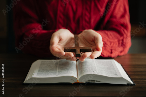 Woman praying on holy bible in the morning.Woman hand with Bible praying. Christian life crisis prayer to god...