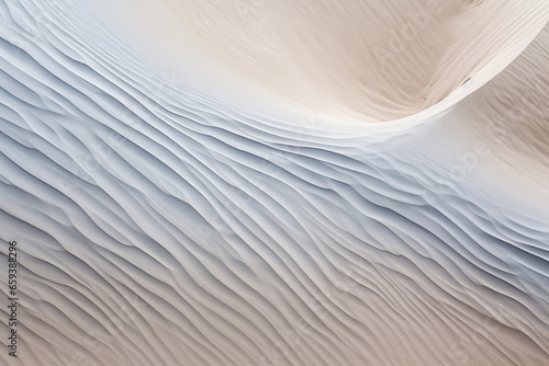 Rippled, bright sand wave pattern with elegance and simplicity, forming an abstract backdrop. © iconogenic