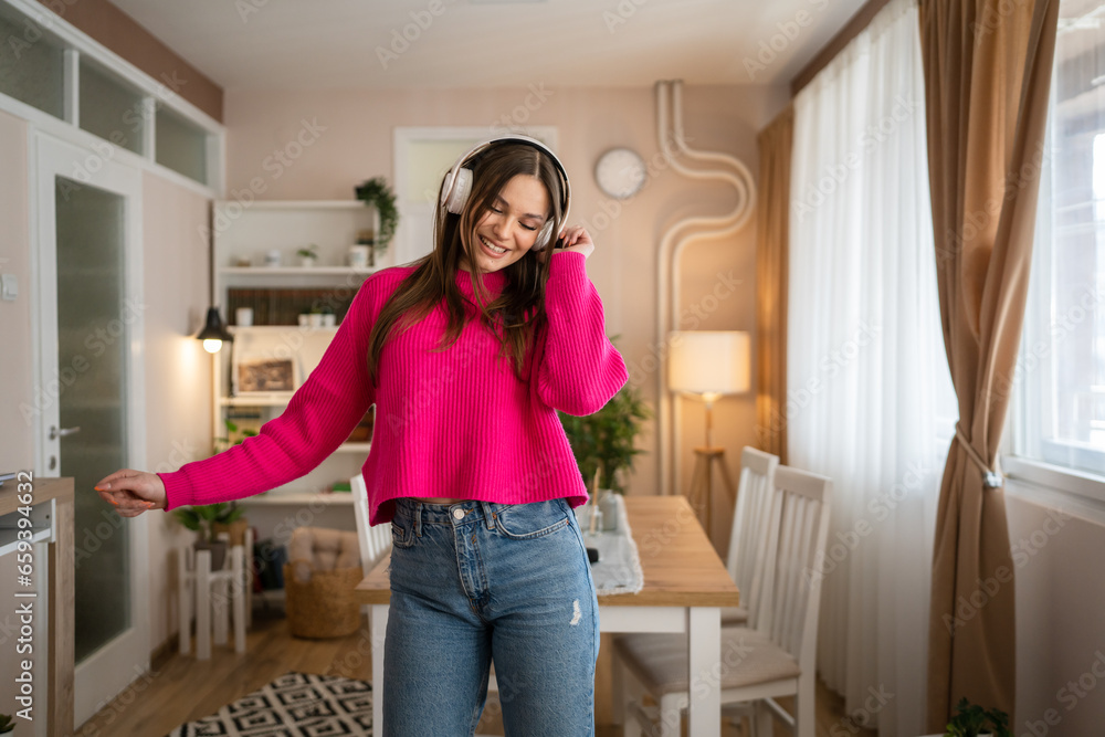 One young woman caucasian dance with headphones at home listen music One young woman caucasian dance with headphones at home listen music