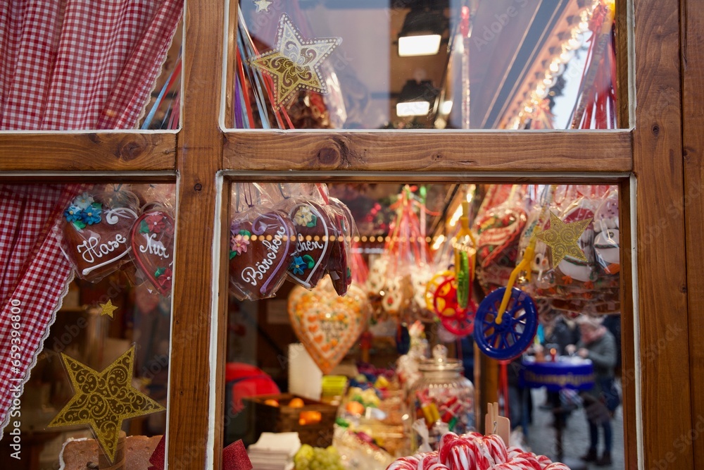 Candy heart cookies and Christmas decorations seen throw window in a German store