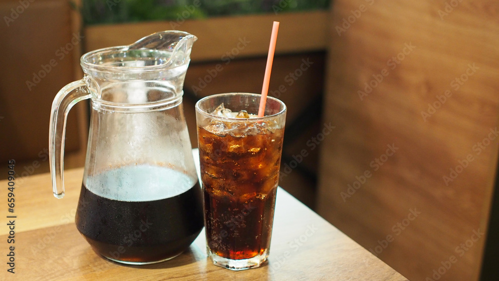 cold cola on wooden table in restaurant. Picture for use in illustrations Background image or copy space cold cola on wooden table in restaurant. Picture for use in illustrations Background image or copy space