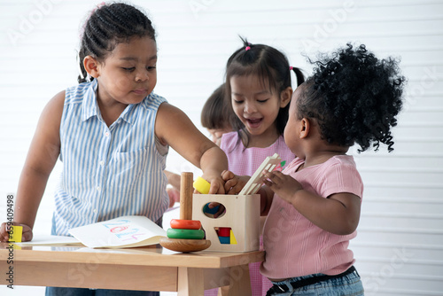 Happy diversity group of 2-4 year olds playing educational toys together  group study concept