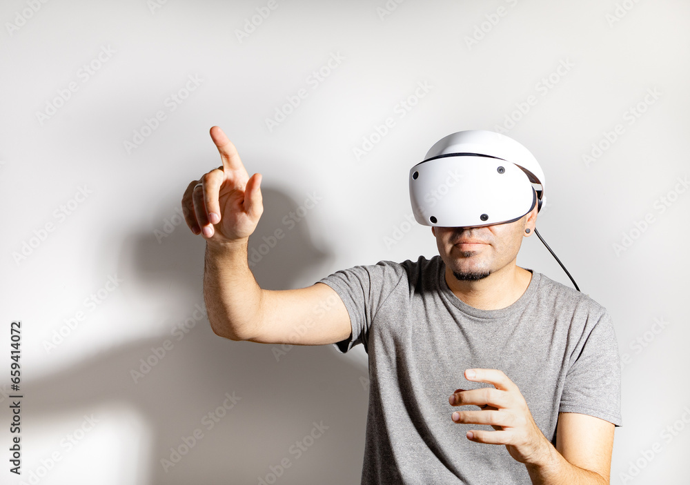 Young man using VR headset. Guy playing with VR glasses Young man using VR headset. Guy playing with VR glasses