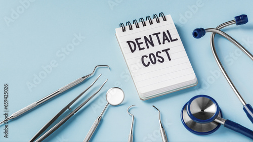 Dental care and treatment cost concept with dental instruments on blue background