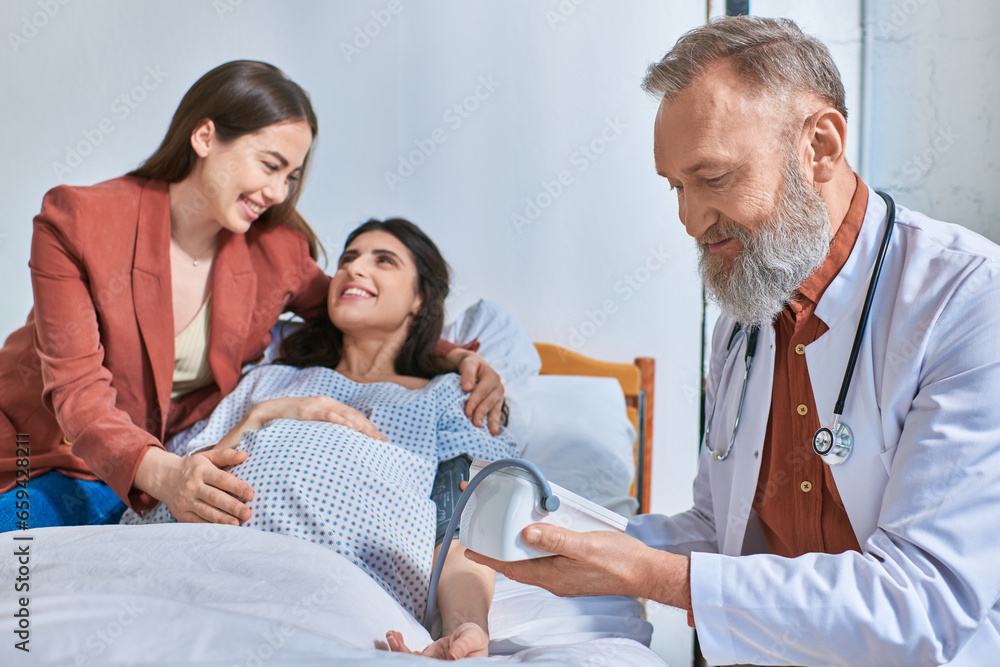 joyous lgbt couple smiling cheerfully at each other while doctor measuring pressure, ivf concept joyous lgbt couple smiling cheerfully at each other while doctor measuring pressure, ivf concept