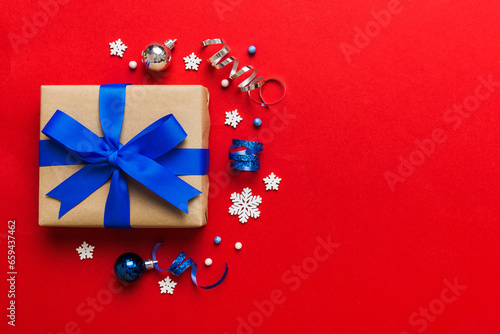 Top view Flat lay Christmas decorations and gift box on colored background with copy space. Christmas or Happy New Year composition