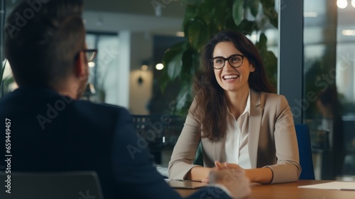 Two business professionals, one woman and one man, collaborate during a corporate office meeting, Gender-diverse Team, Co-workers, Office Collaboration