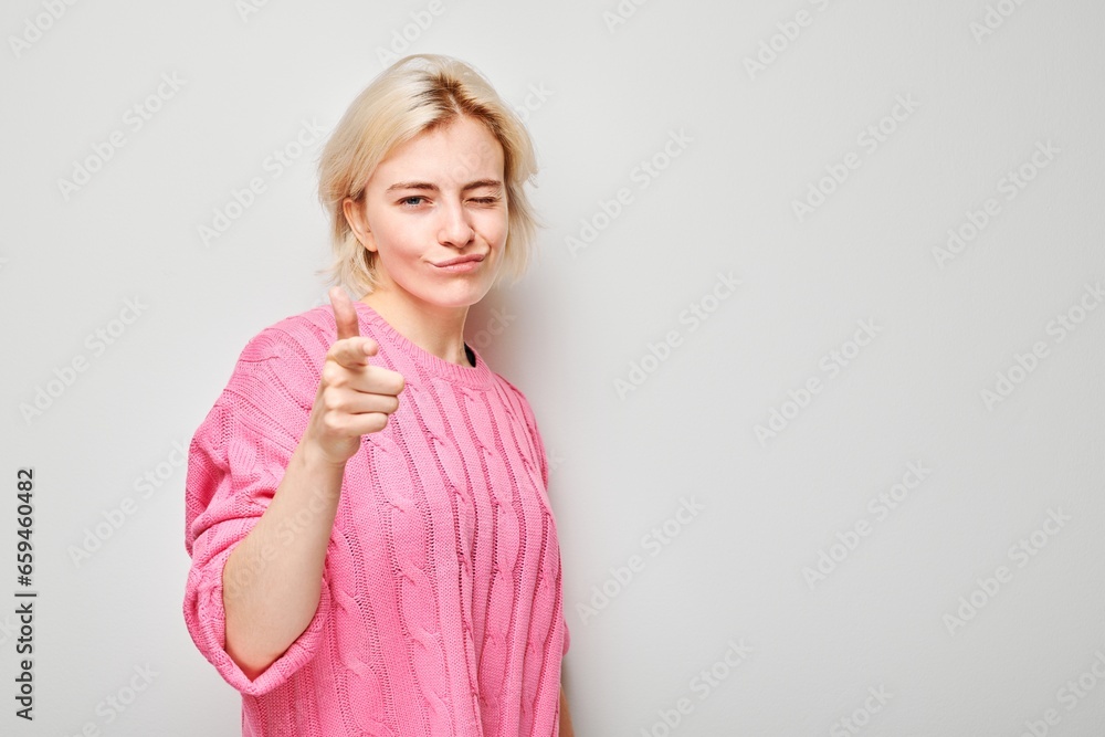 Portrait of confident girl chooses you points finger at camera isolated on white studio background. Welcome gesture, join our team concept Portrait of confident girl chooses you points finger at camera isolated on white studio background. Welcome gesture, join our team concept