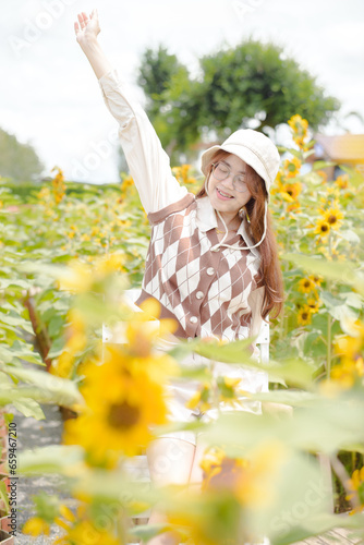 Portrait young woman in a field of sunflowers, Happiness asian woman in a field of sunflowers, Portrait asian woman in a field of sunflowers 