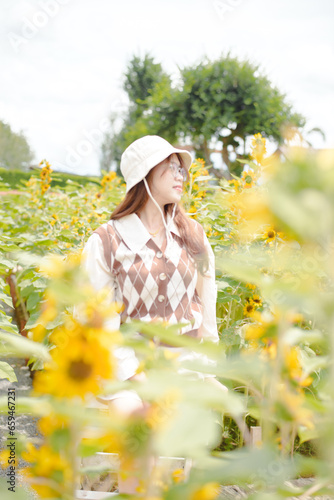 Portrait young woman in a field of sunflowers, Happiness asian woman in a field of sunflowers, Portrait asian woman in a field of sunflowers 