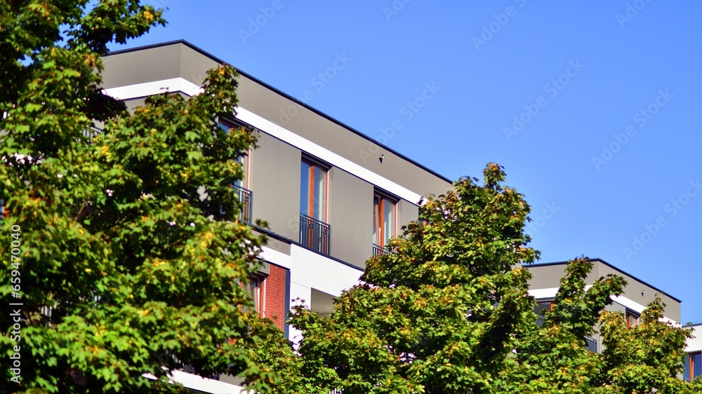 Green community. Eco apartment building saving energy and fresh air concept. Block of flats in beautiful green public