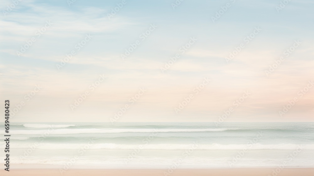 A beach with a pastel colored sky and the ocean in the background.