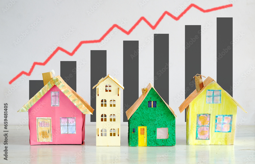 Rising rents, heating costs and prices for homes, model homes in front of  financial diagrams.Real estate business concept. Free copy space