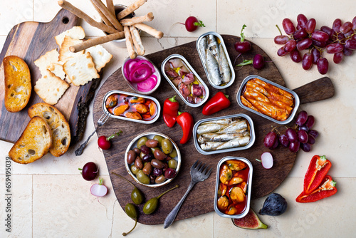 Tinned fish charcuterie board. Seacuterie appetizers platter with canned fish and seafood. Food trend for party and tinned fish date night