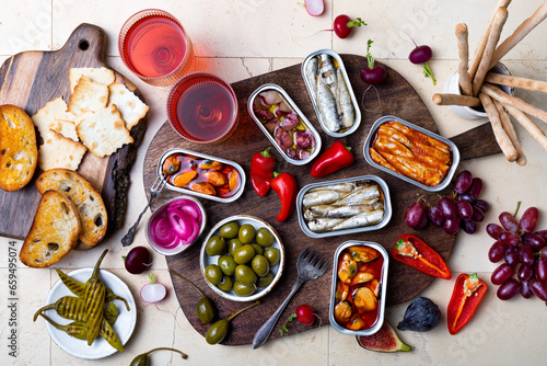 Tinned fish charcuterie board. Seacuterie appetizers platter with canned fish and seafood. Food trend for party and tinned fish date night photo