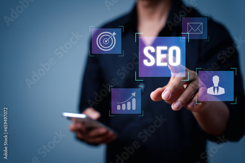 Search engine optimization marketing ranking. Working on computer with the icon of online search engine, abbreviation SEO and SEO symbol. Digital marketing strategy of promote traffic to website