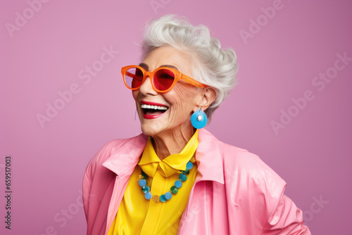 Beautiful stylish elderly woman with grey hair in elegant clothes and glasses