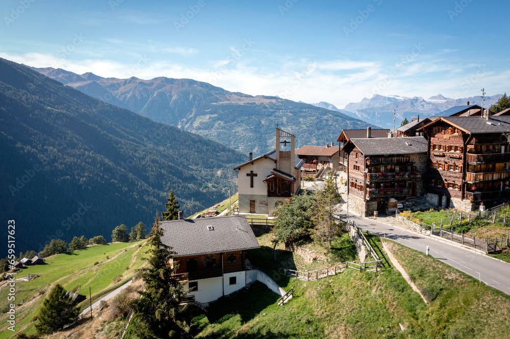 drone view of old traditional village in the mountains of Val d'Herens in the Swiss Alps