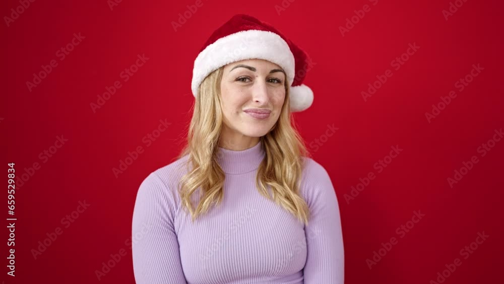 Young beautiful hispanic woman wearing christmas hat saying yes with head over isolated red background Young beautiful hispanic woman wearing christmas hat saying yes with head over isolated red background