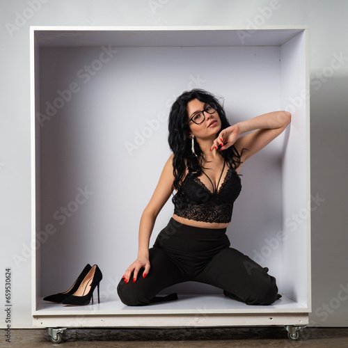 Young sexy slim woman in the cube.