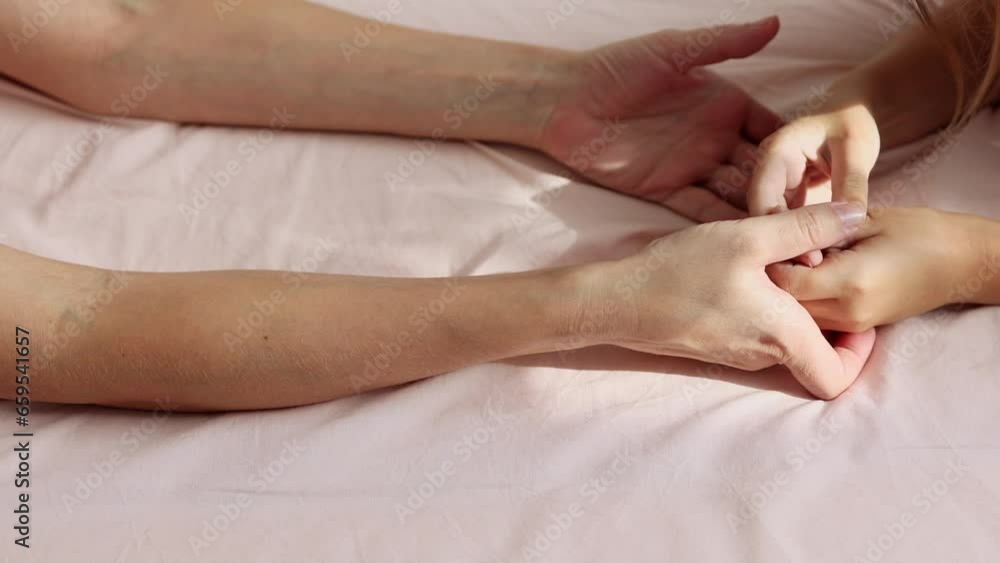Top view of the hands of mom and little daughter touching each other. Close-up. The concept of love, tenderness and trust in the family Top view of the hands of mom and little daughter touching each other. Close-up. The concept of love, tenderness and trust in the family